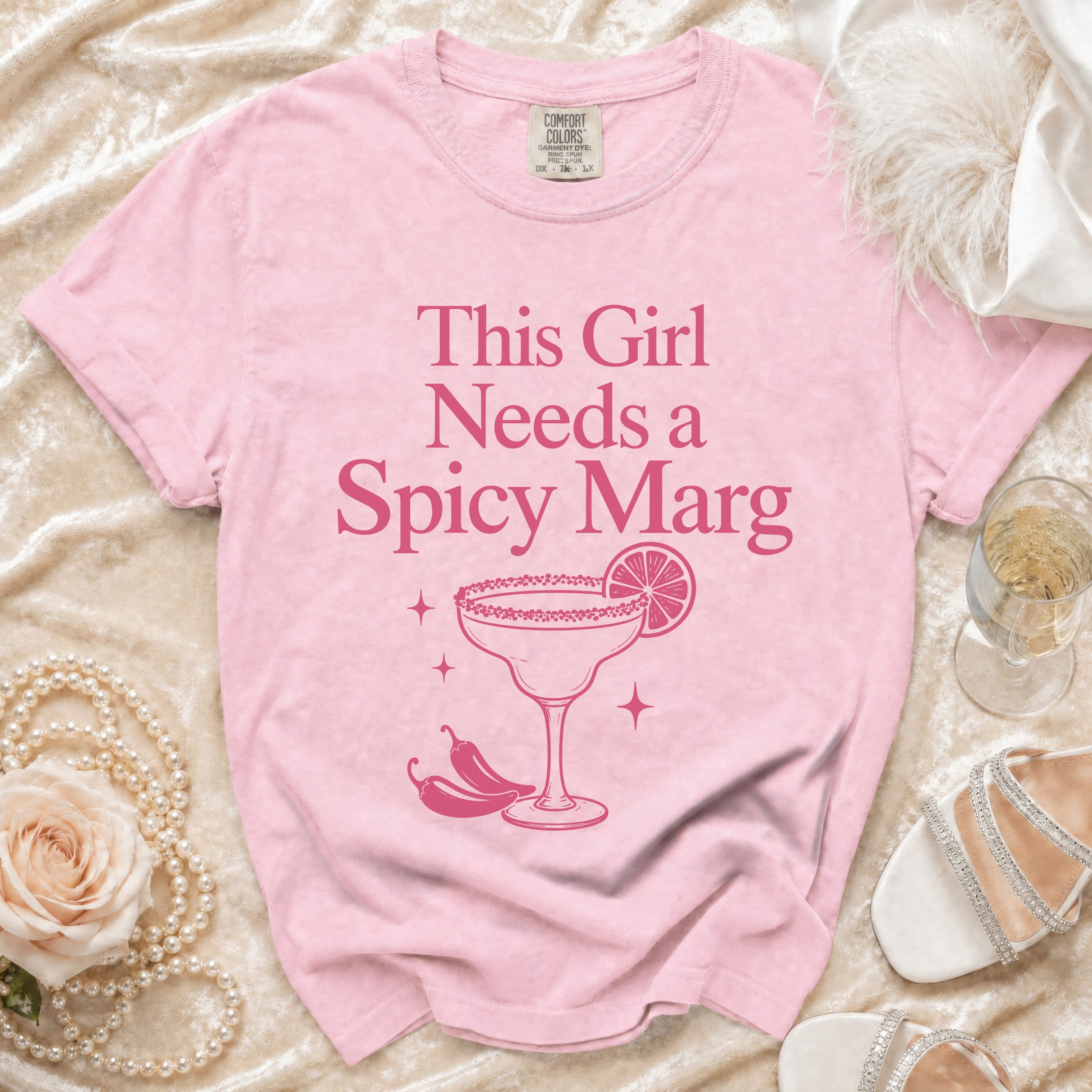 Pink t-shirt with "This Girl Needs a Spicy Marg" text and margarita graphic.