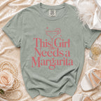 Gray t-shirt with pink text reading "This Girl Needs a Margarita" and a margarita graphic.
