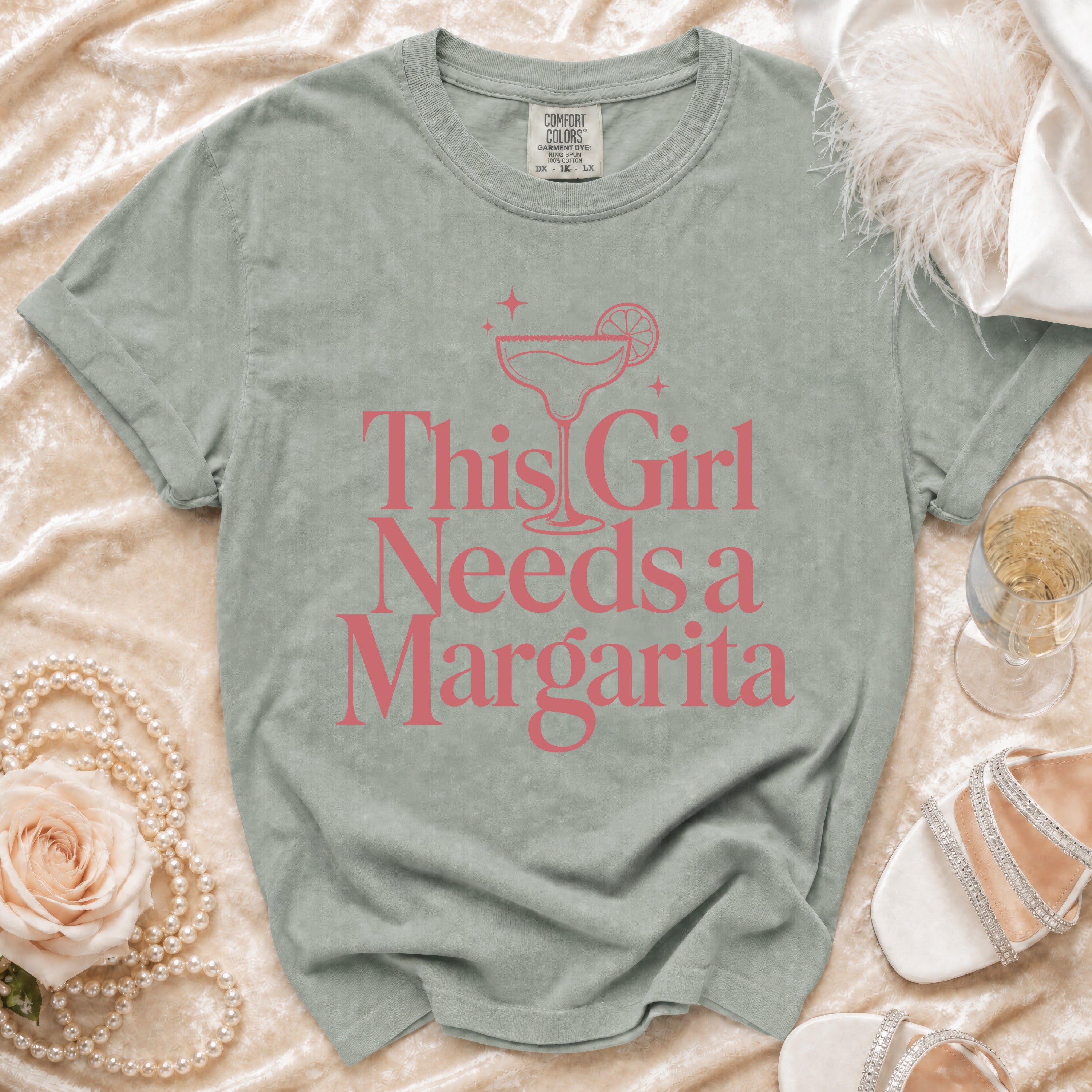 Gray t-shirt with pink text reading "This Girl Needs a Margarita" and a margarita graphic.