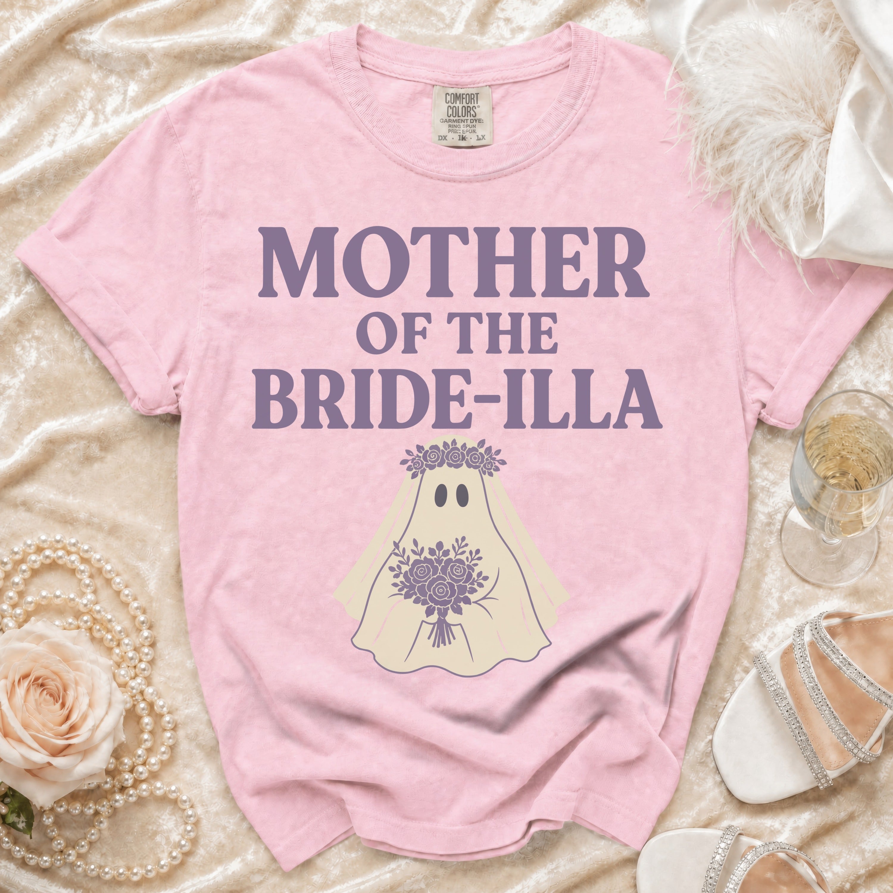Pink Comfort Colors t-shirt with "MOTHER OF THE BRIDE-ILLA" text and ghost graphic.