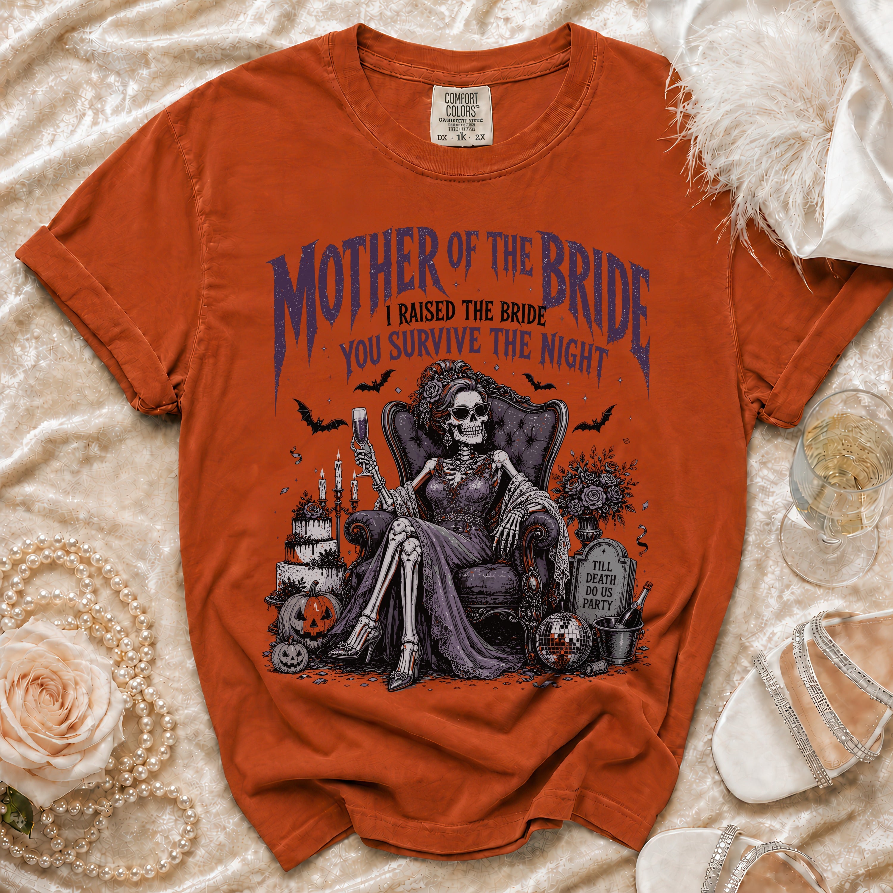 Orange Comfort Colors t-shirt with a skeleton "Mother of the Bride" graphic.