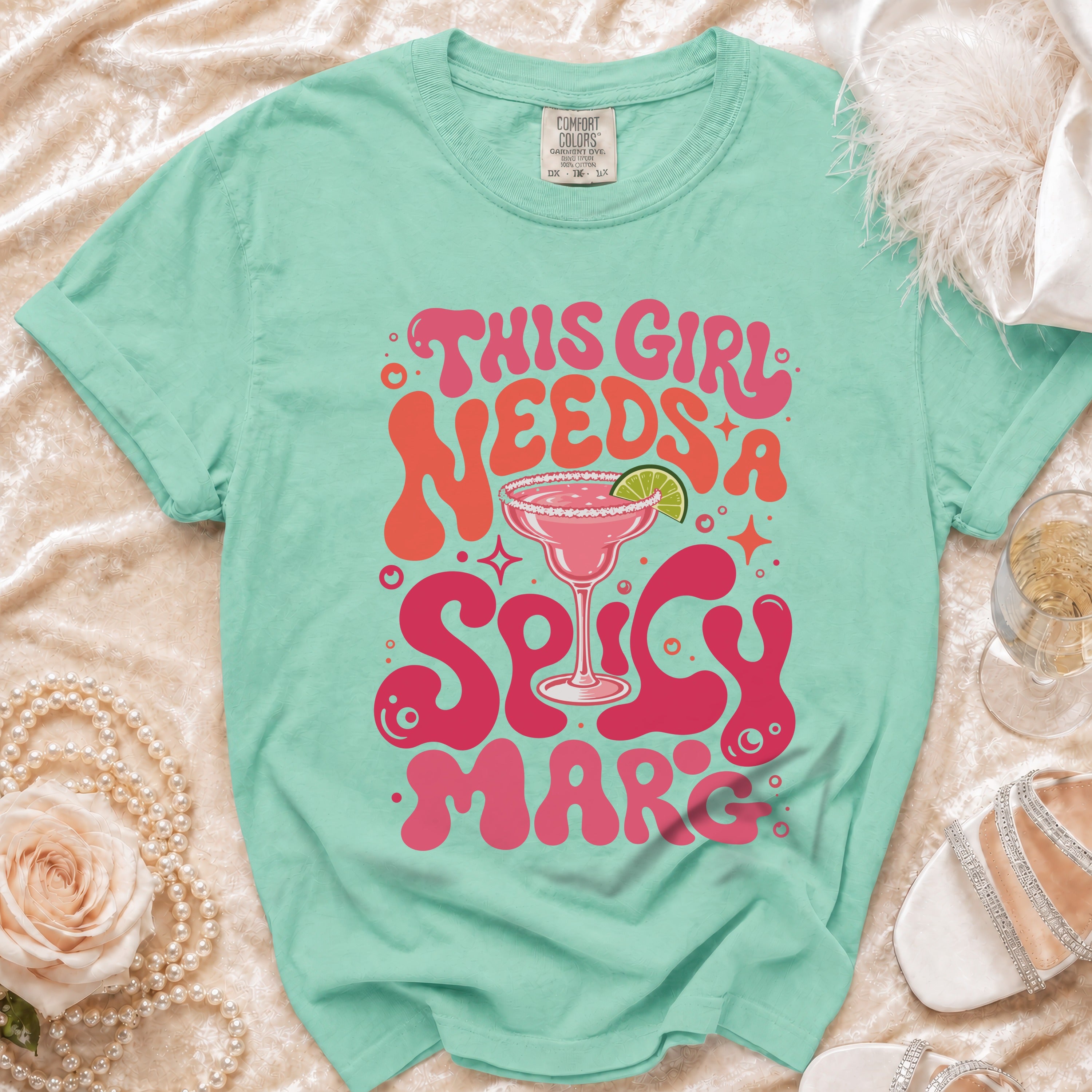 Mint green t-shirt with "This Girl Needs A Spicy Mar" text and margarita graphic.
