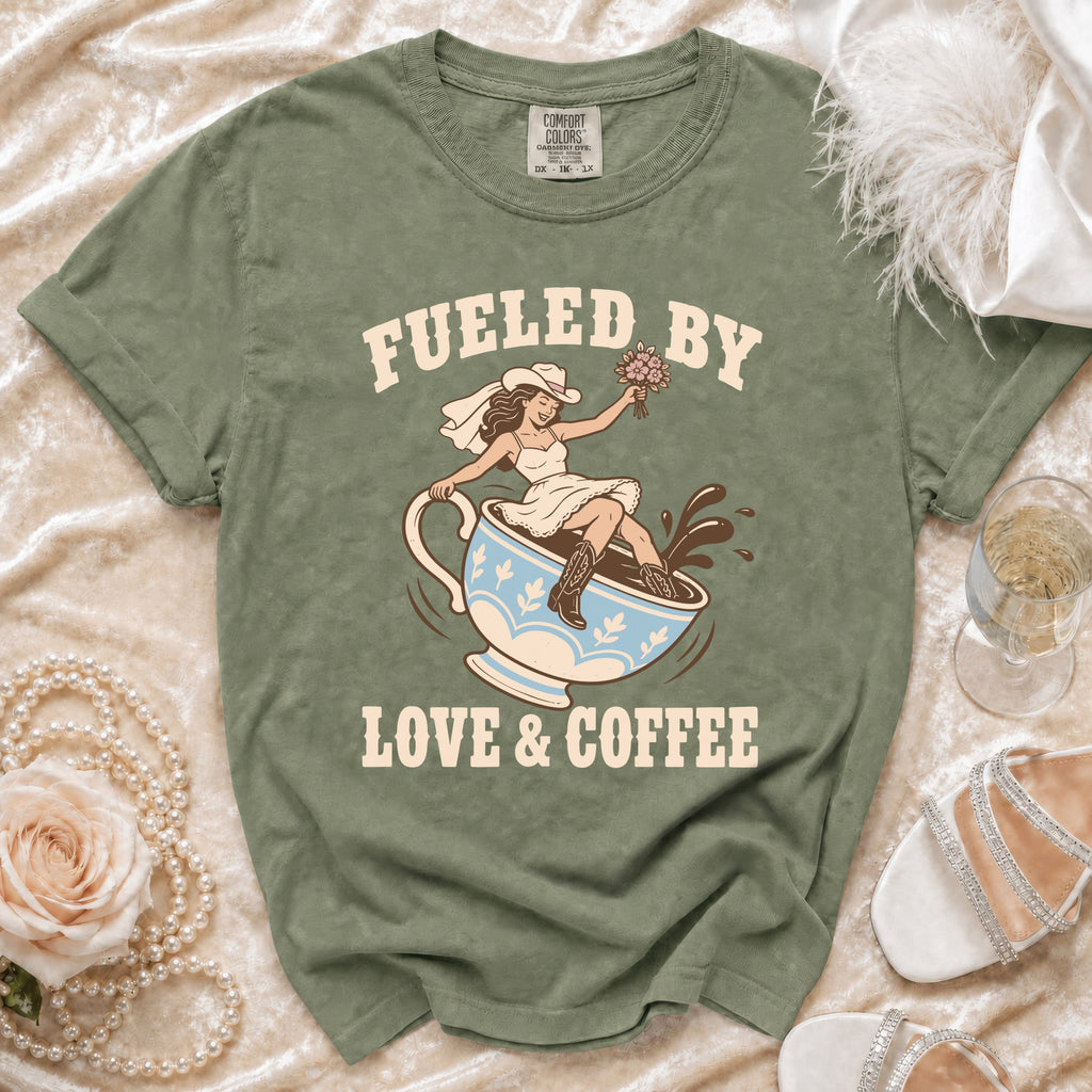 Green t-shirt with bride riding coffee cup graphic and text "Fueled by Love & Coffee".