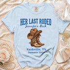 Light blue t-shirt with "Her Last Rodeo" text and cowboy boots graphic.