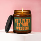 Amber glass candle with lit flame and label "SMells Like SH*T FACED AT YOUR WEDDING".