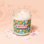 Candle with floral label reading "Engaged and Glowing! With All The Sparkle".