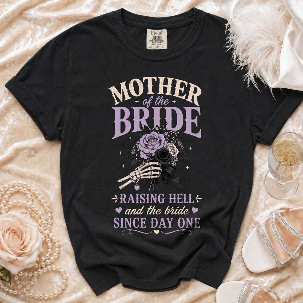 Black t-shirt featuring Mother of the Bride text, a skeleton hand holding roses, and the phrase Raising Hell and the Bride Since Day One.