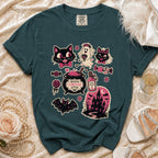 Teal t-shirt with "Brewing Forever After" Halloween graphics including cats and a haunted house.