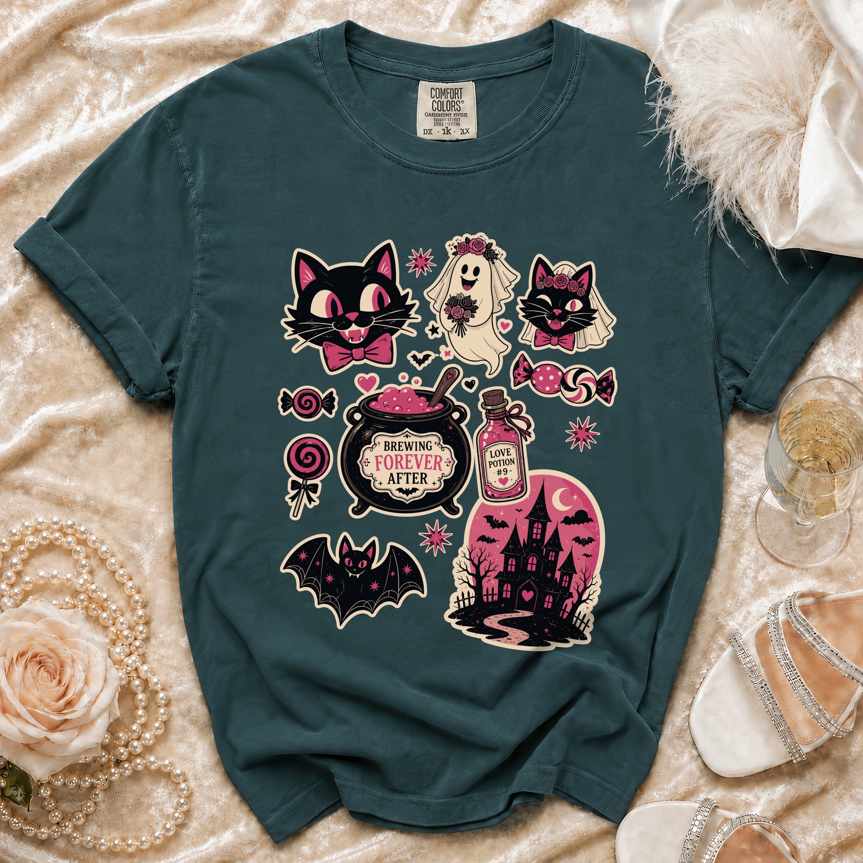 Teal t-shirt with "Brewing Forever After" Halloween graphics including cats and a haunted house.