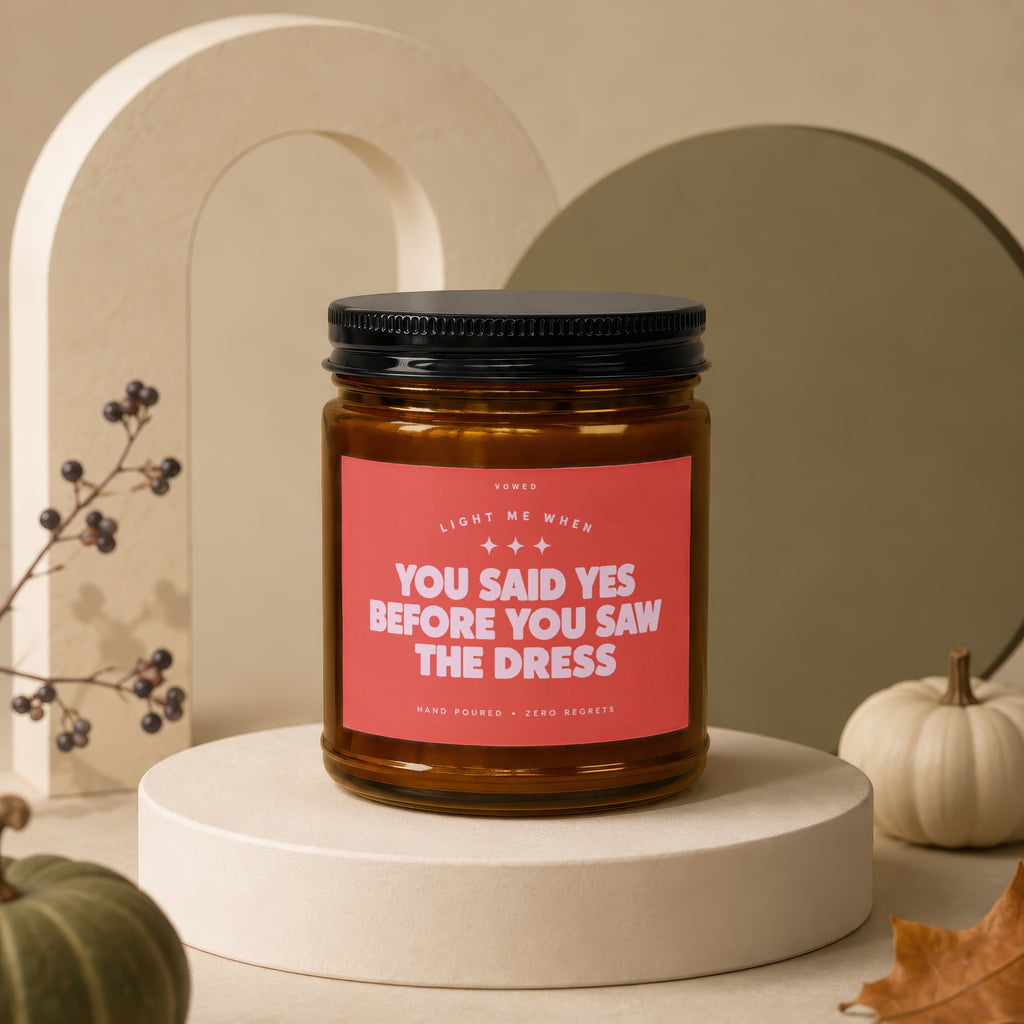 Amber candle with pink label reading "You Said Yes Before You Saw The Dress."