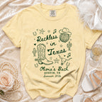 Yellow t-shirt with "Reckless in Texas" design, cowboy boots, and sheriff star.