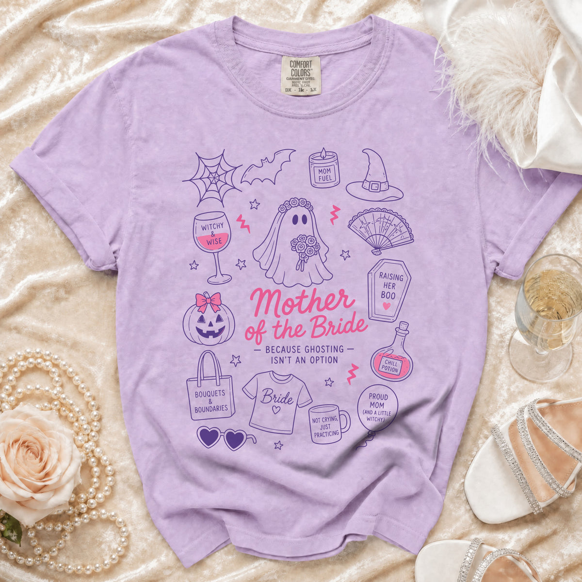 Purple t-shirt with "Mother of the Bride" and witchy-themed illustrations.
