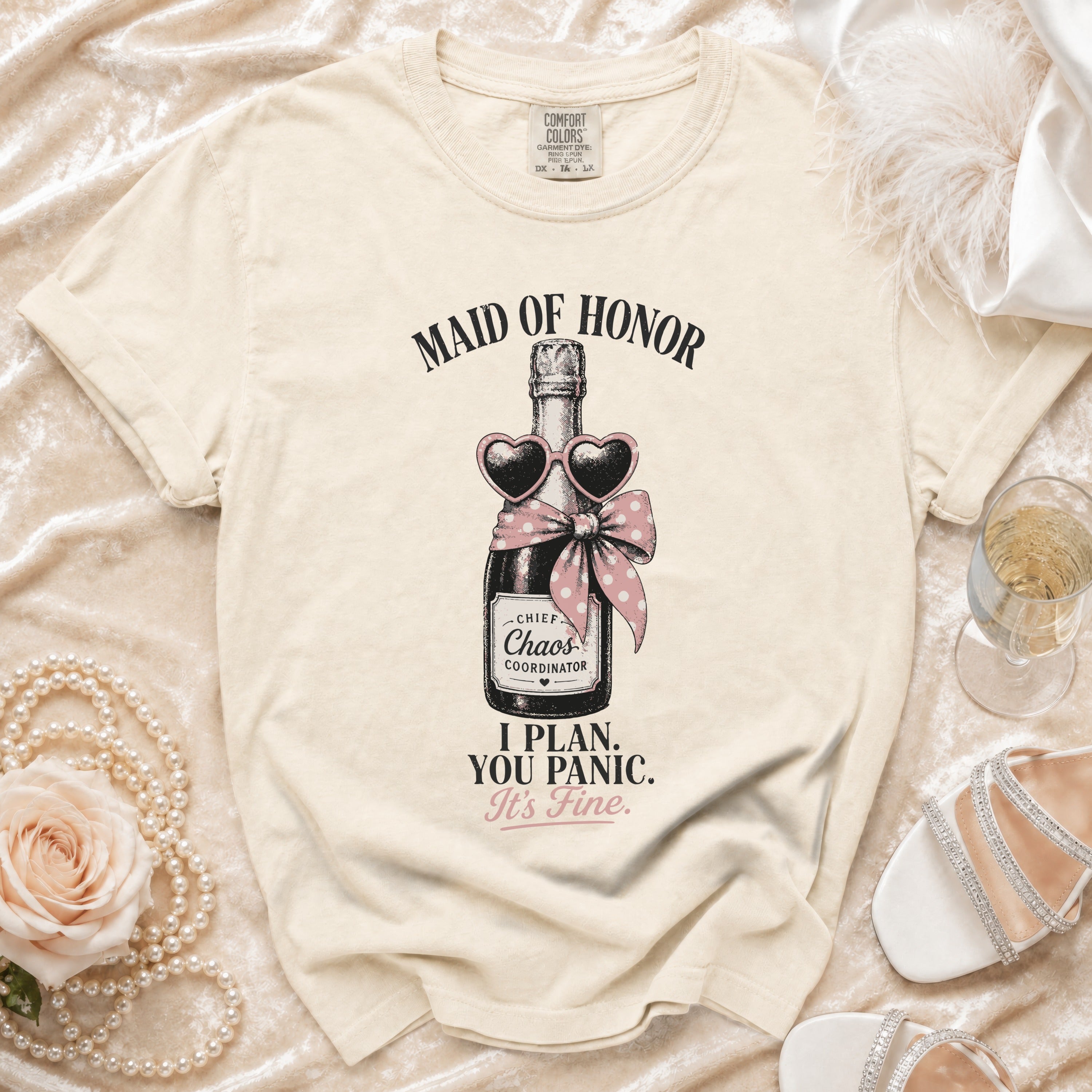 Cream t-shirt with "Maid of Honor" and champagne bottle graphic.