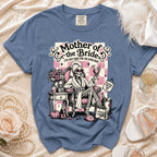 Blue t-shirt with "Mother of the Bride" graphic featuring a skeleton in a robe.
