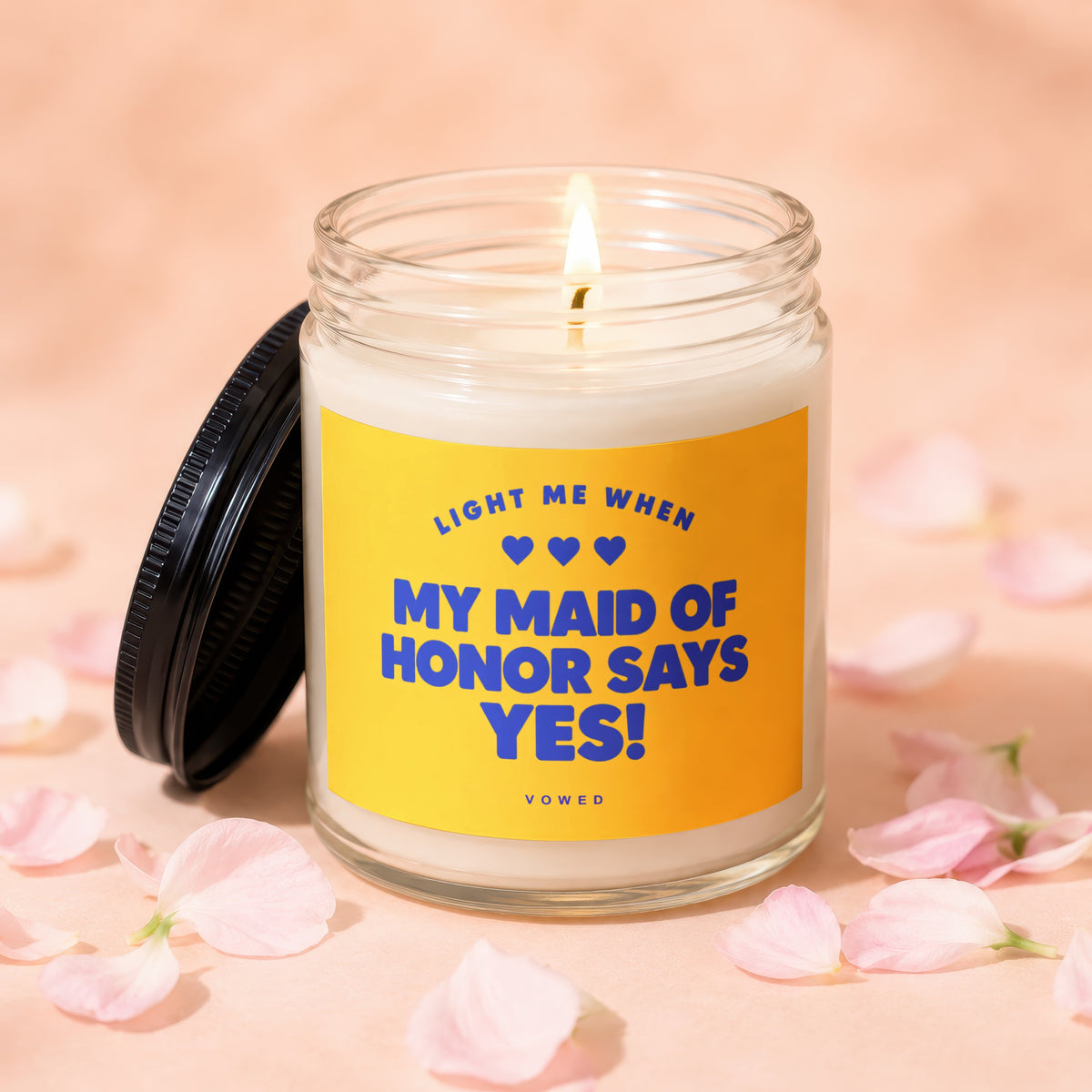 Glass candle with lit wick and lid off, reads "Light me when My Maid of Honor Says YES!"