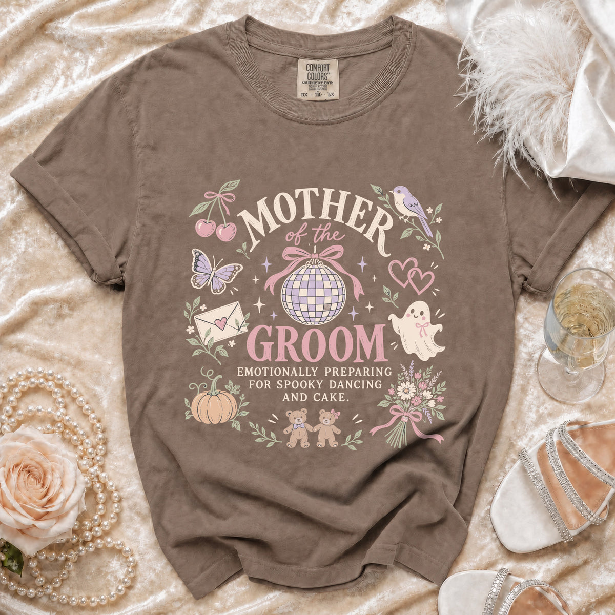 Brown t-shirt with "Mother of the Groom" design, spooky dancing, and cake.