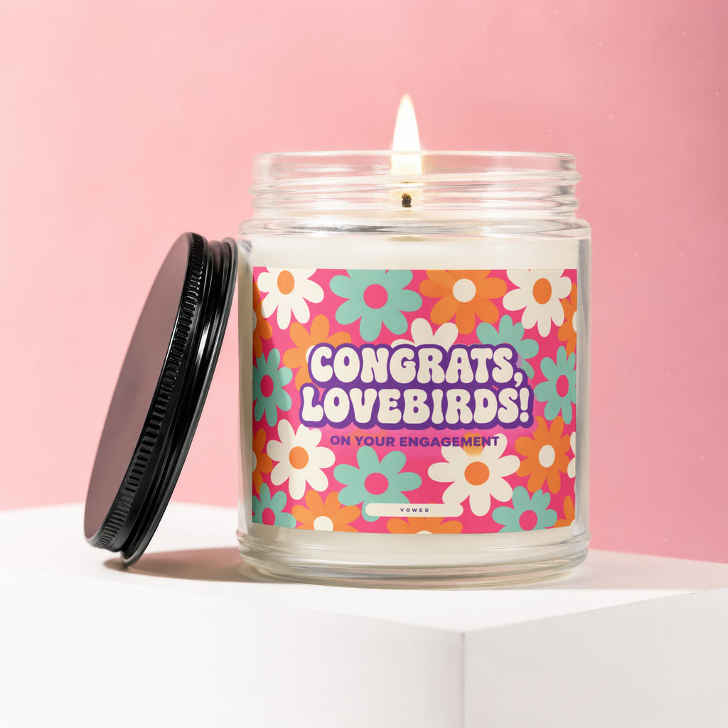 Candle with "Congrats, Lovebirds! On Your Engagement" text and floral design.
