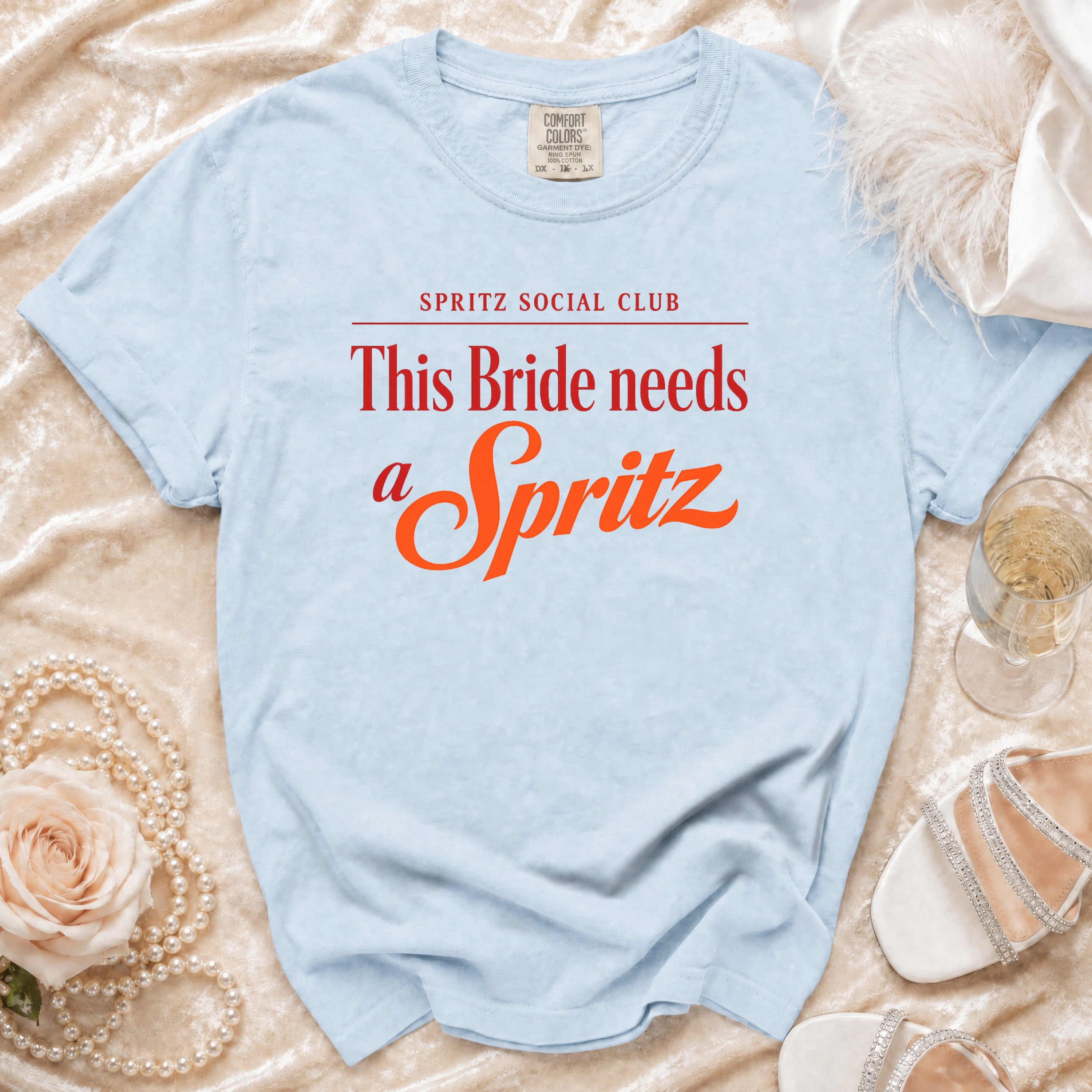 Light blue t-shirt with text "SPRITZ SOCIAL CLUB This Bride needs a Spritz".