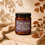 Amber candle with "Fabulous Mother of the Bride" text on a plum label.