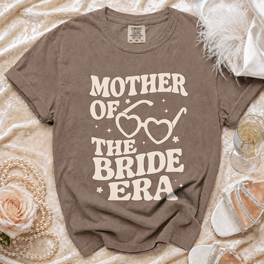 Brown t-shirt with "Mother of the Bride Era" graphic and heart sunglasses.