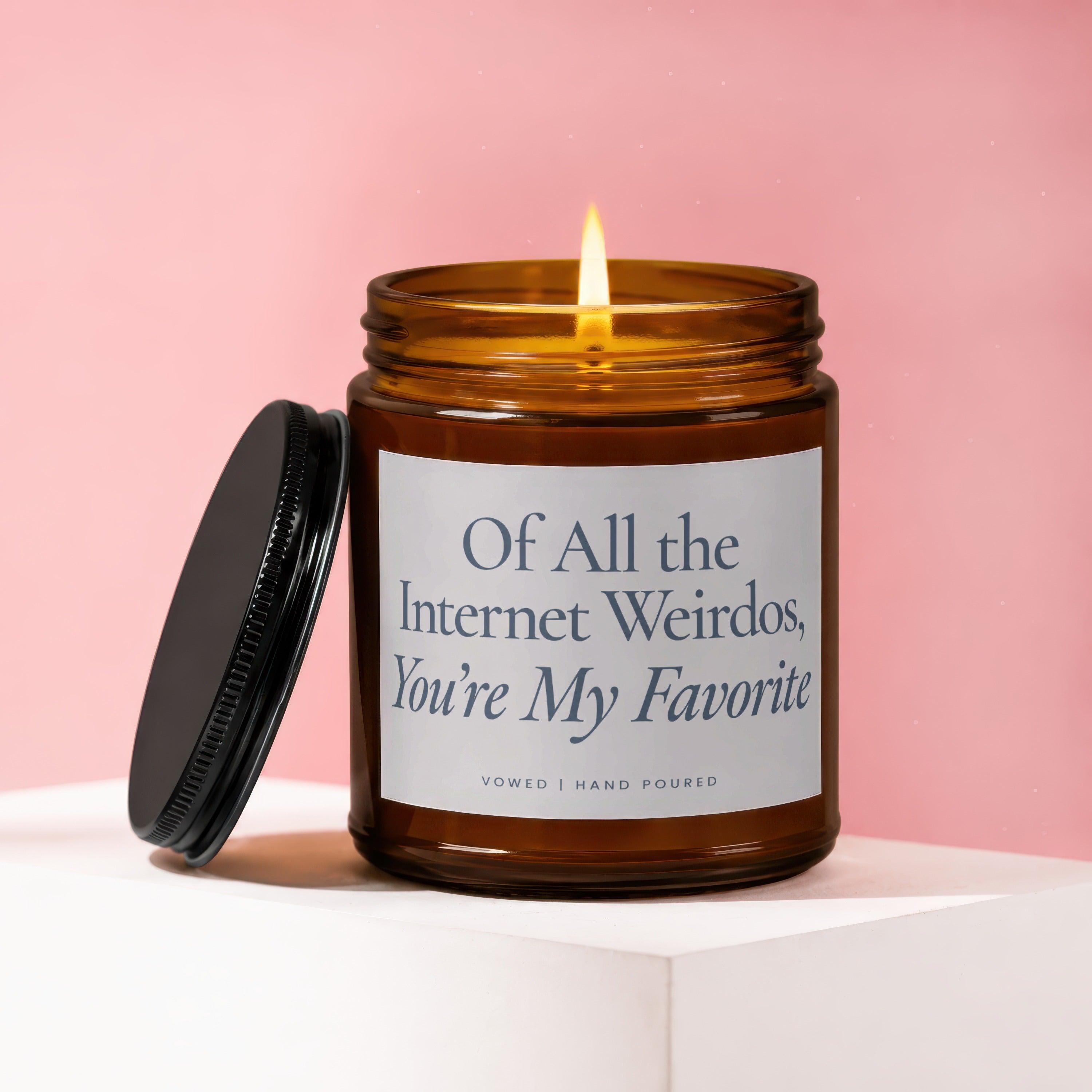 Amber candle with lit flame, lid to the left, text "Of All the Internet Weirdos, You're My Favorite".