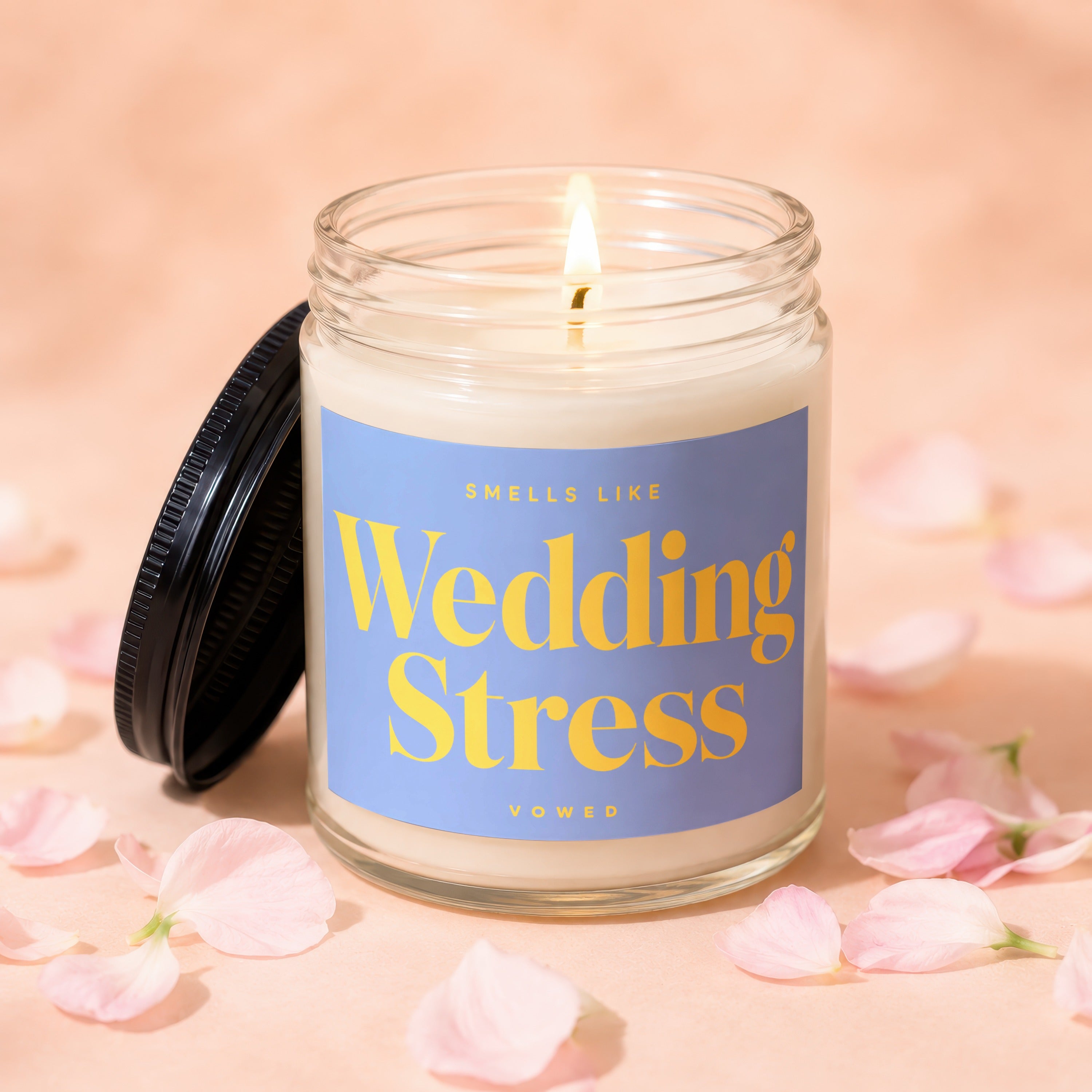 Glass candle with "Smells Like Wedding Stress" on a lavender label.