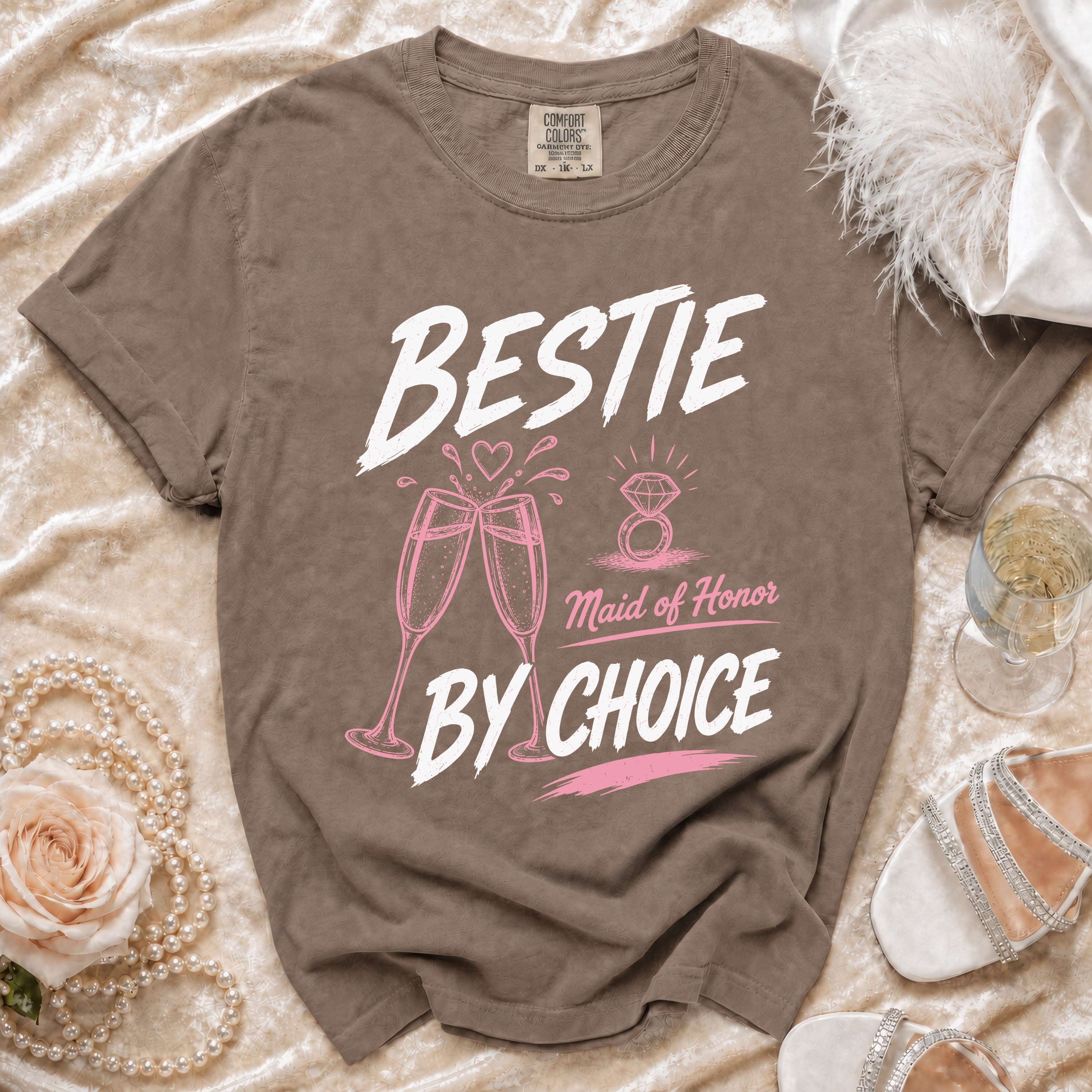 Brown t-shirt with "BESTIE Maid of Honor BY CHOICE" text, champagne glasses, and ring graphic.