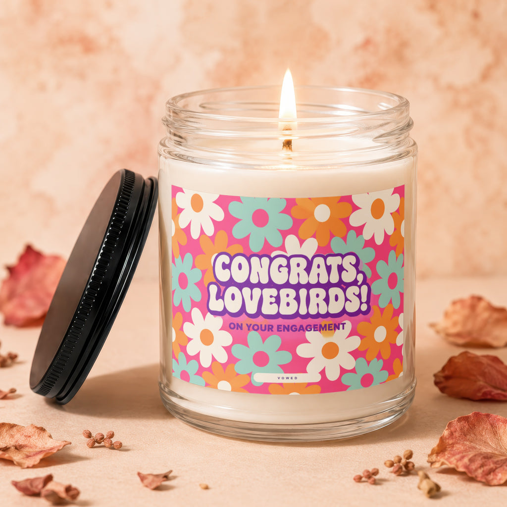 Candle with "Congrats, Lovebirds! On Your Engagement" text on retro floral label.