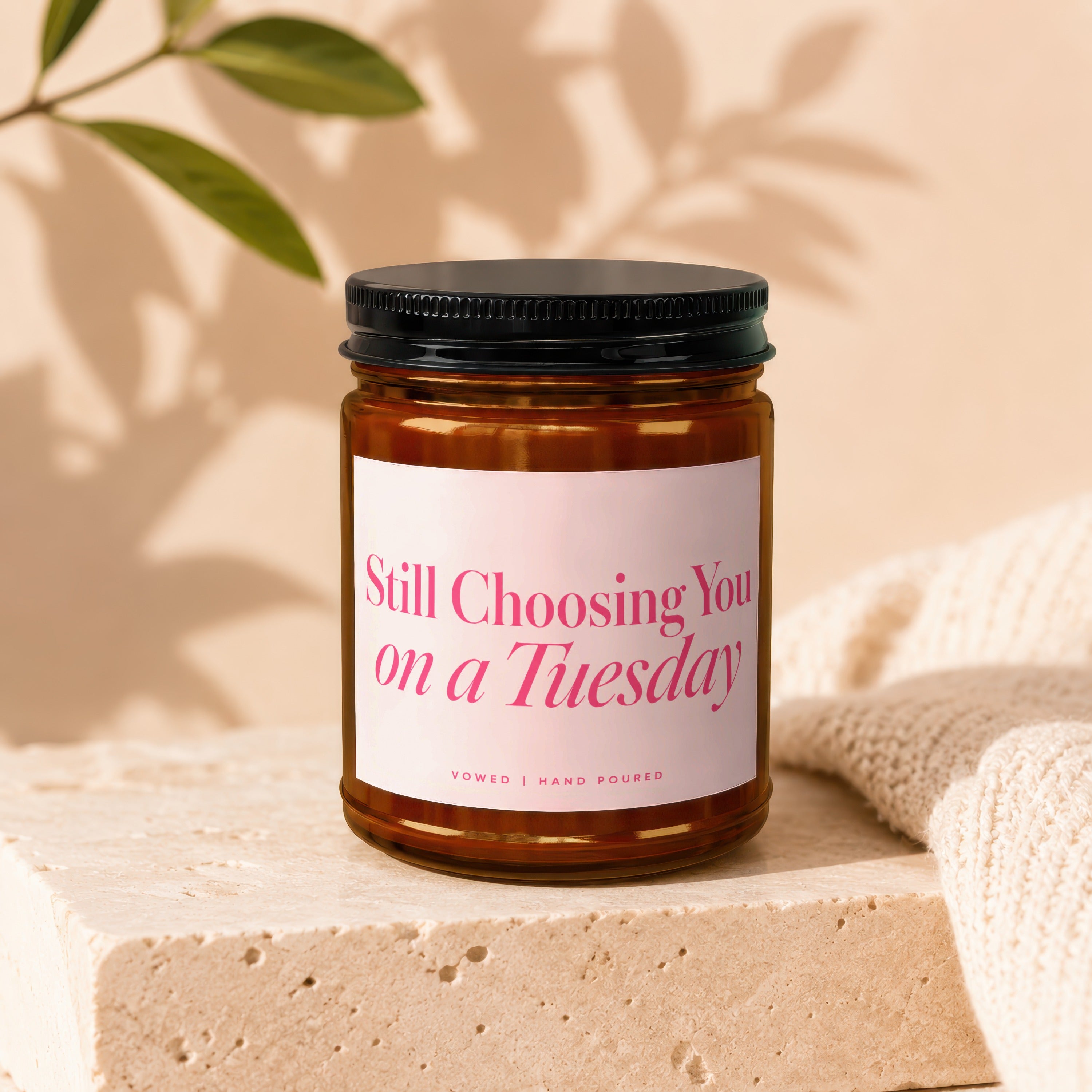 Amber jar candle with pink text that reads "Still Choosing You on a Tuesday".