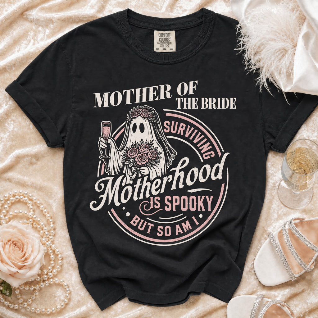 Black t-shirt with "Mother of the Bride Surviving Motherhood is Spooky But So Am I" graphic.