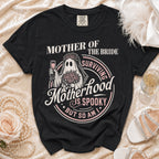 Black t-shirt with "Mother of the Bride Surviving Motherhood is Spooky But So Am I" graphic.