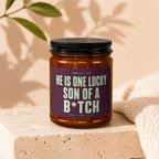 Candle with text "HE IS ONE LUCKY SON OF A B*TCH", hand-poured.