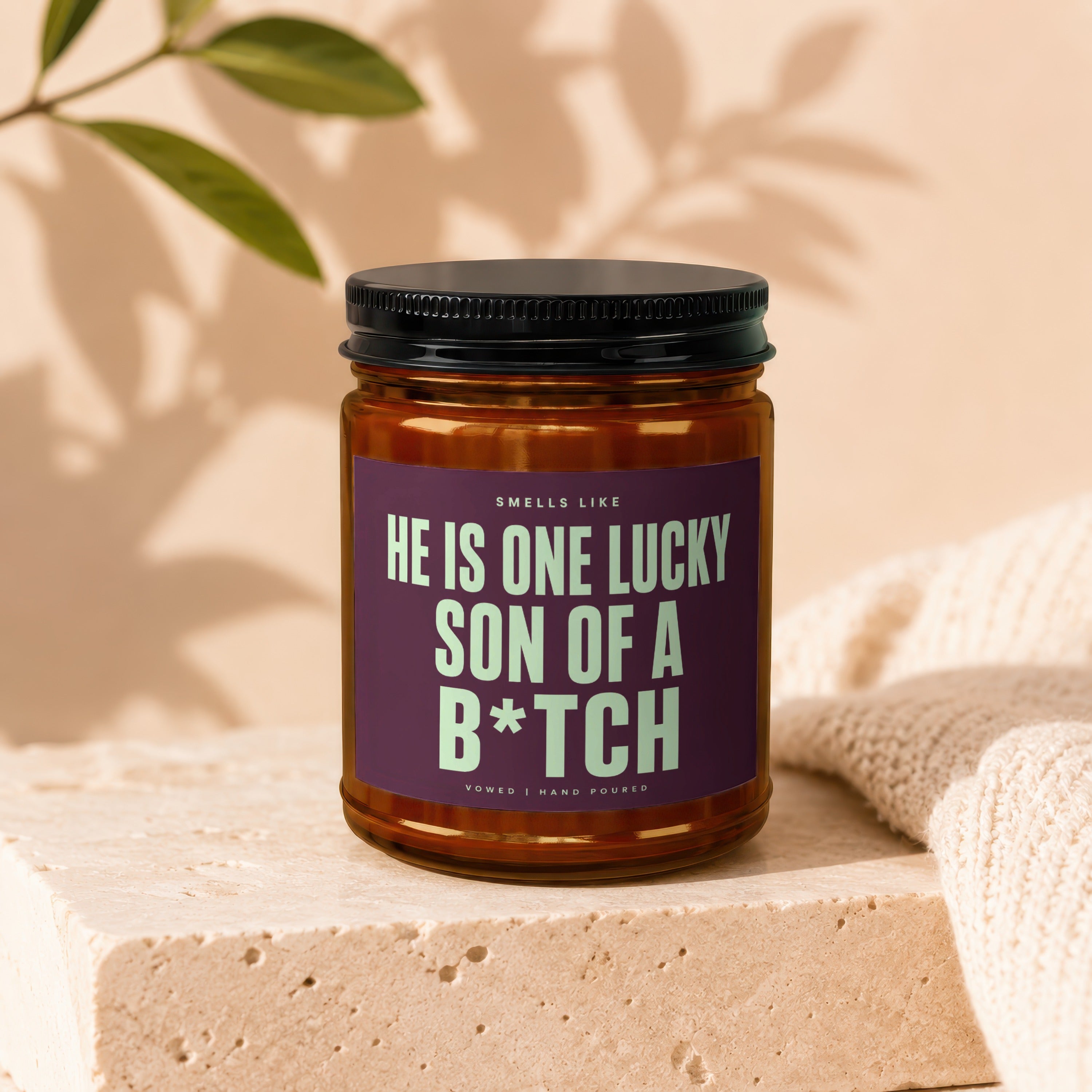 Candle with text "HE IS ONE LUCKY SON OF A B*TCH", hand-poured.