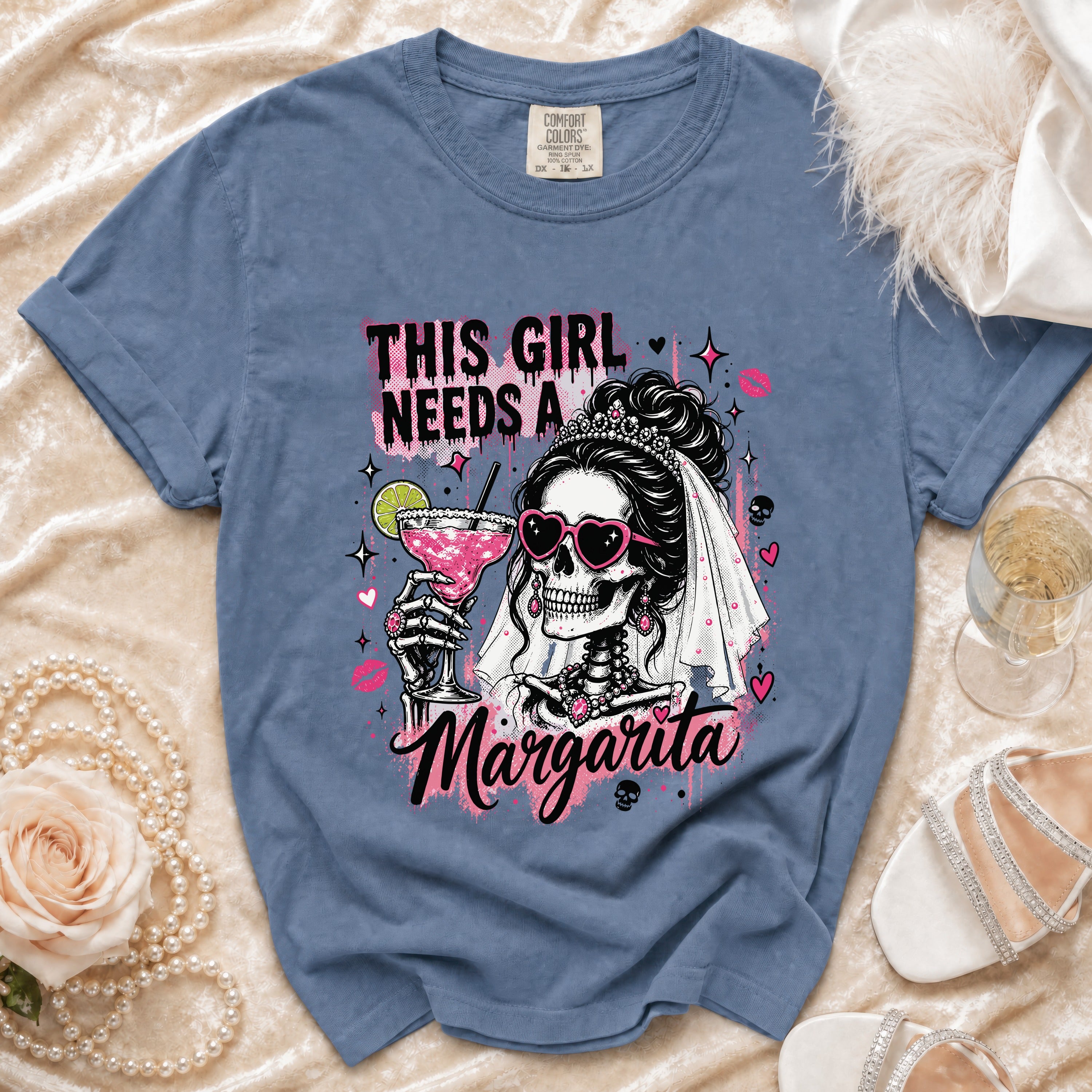 Skeleton bride graphic on blue t-shirt reads "This girl needs a Margarita."