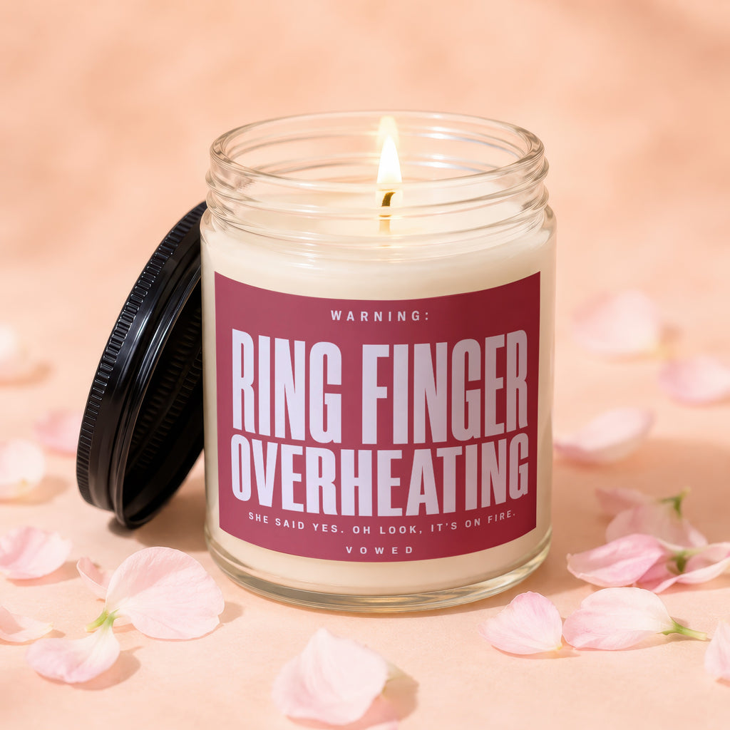 Candle with text "Ring Finger Overheating" and "She said yes. Oh look, it's on fire."
