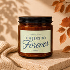 Amber candle with label "Smells Like Cheers To Forever Vowed".