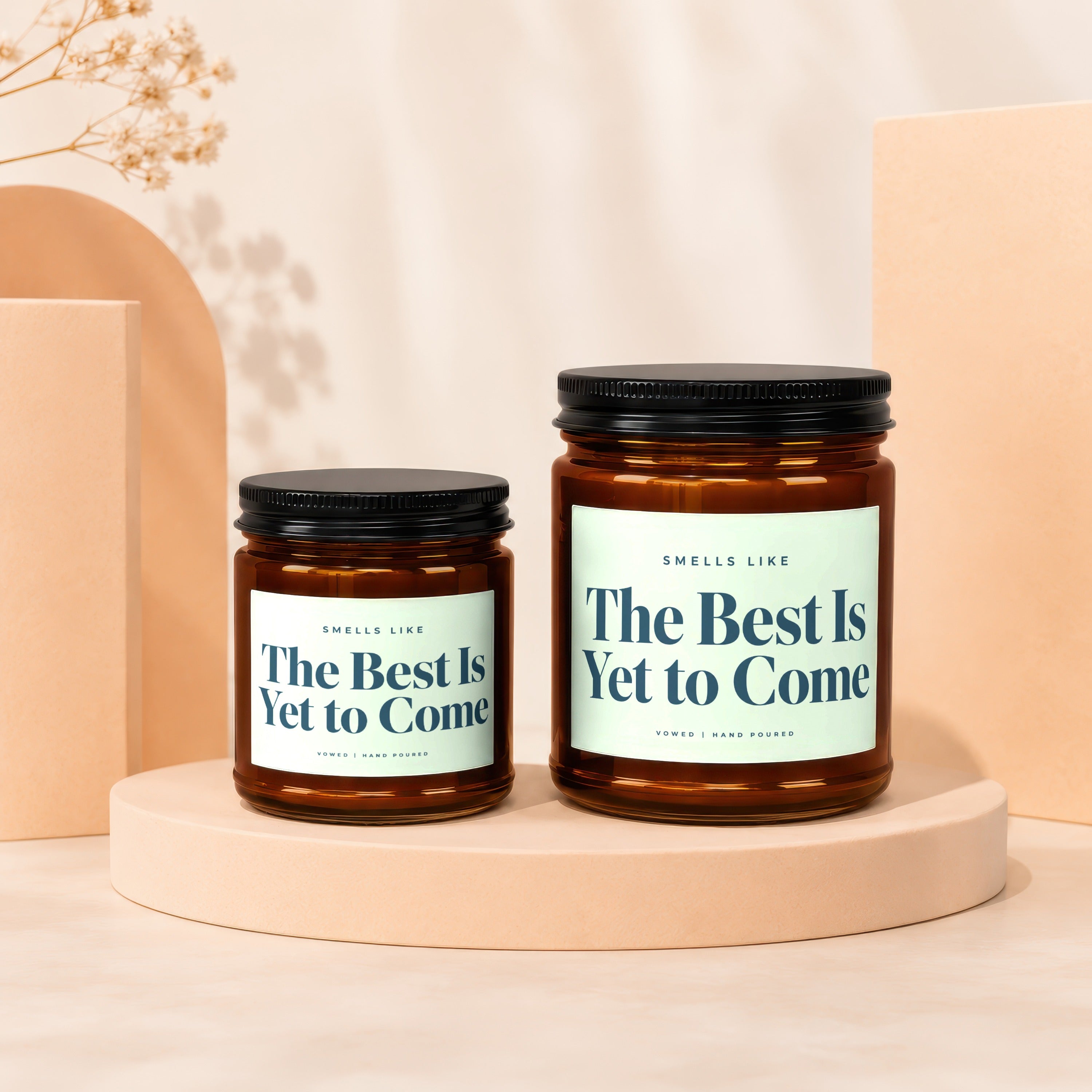 Two amber glass candles with "The Best Is Yet to Come" text.