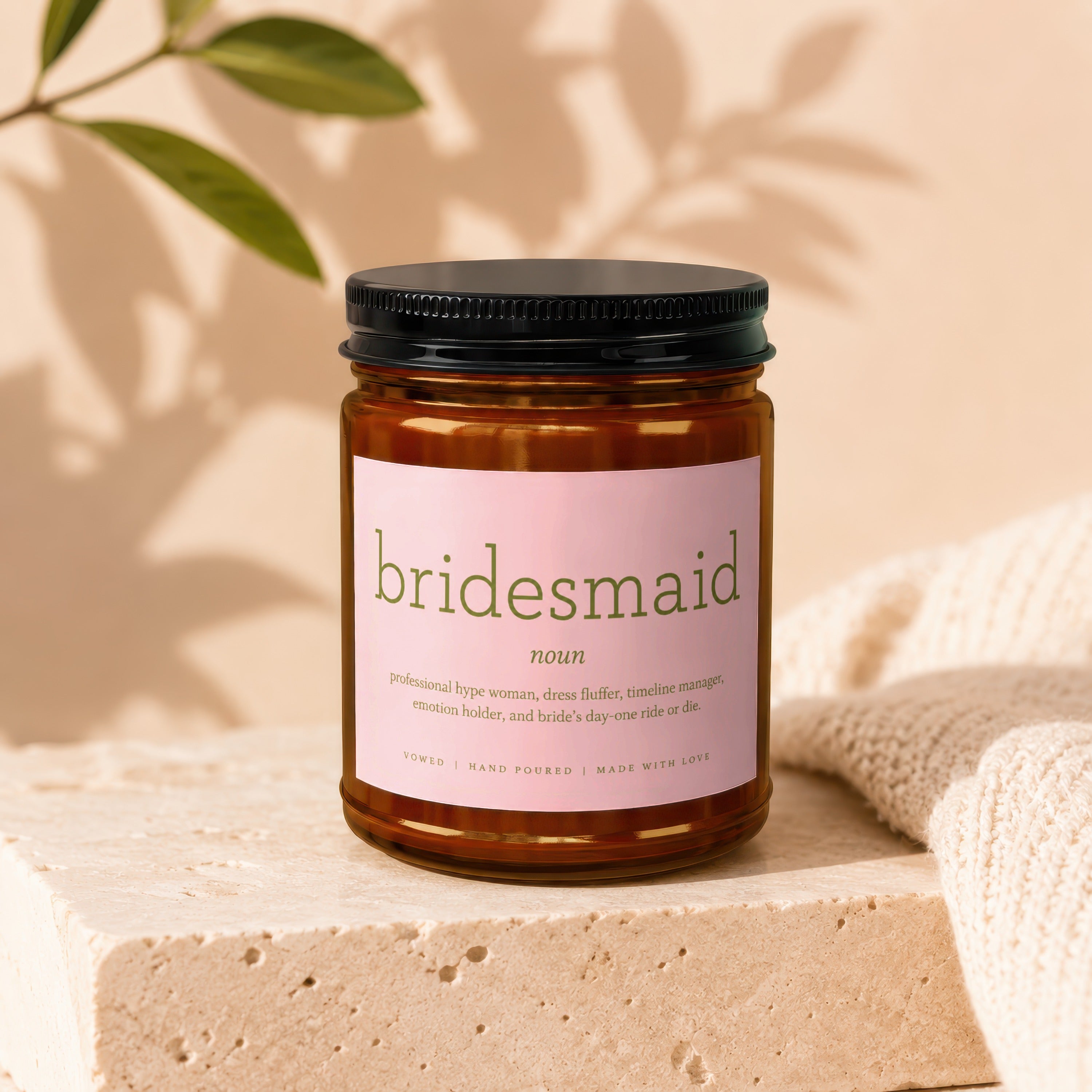 Amber glass candle labeled "bridesmaid noun" with humorous description.
