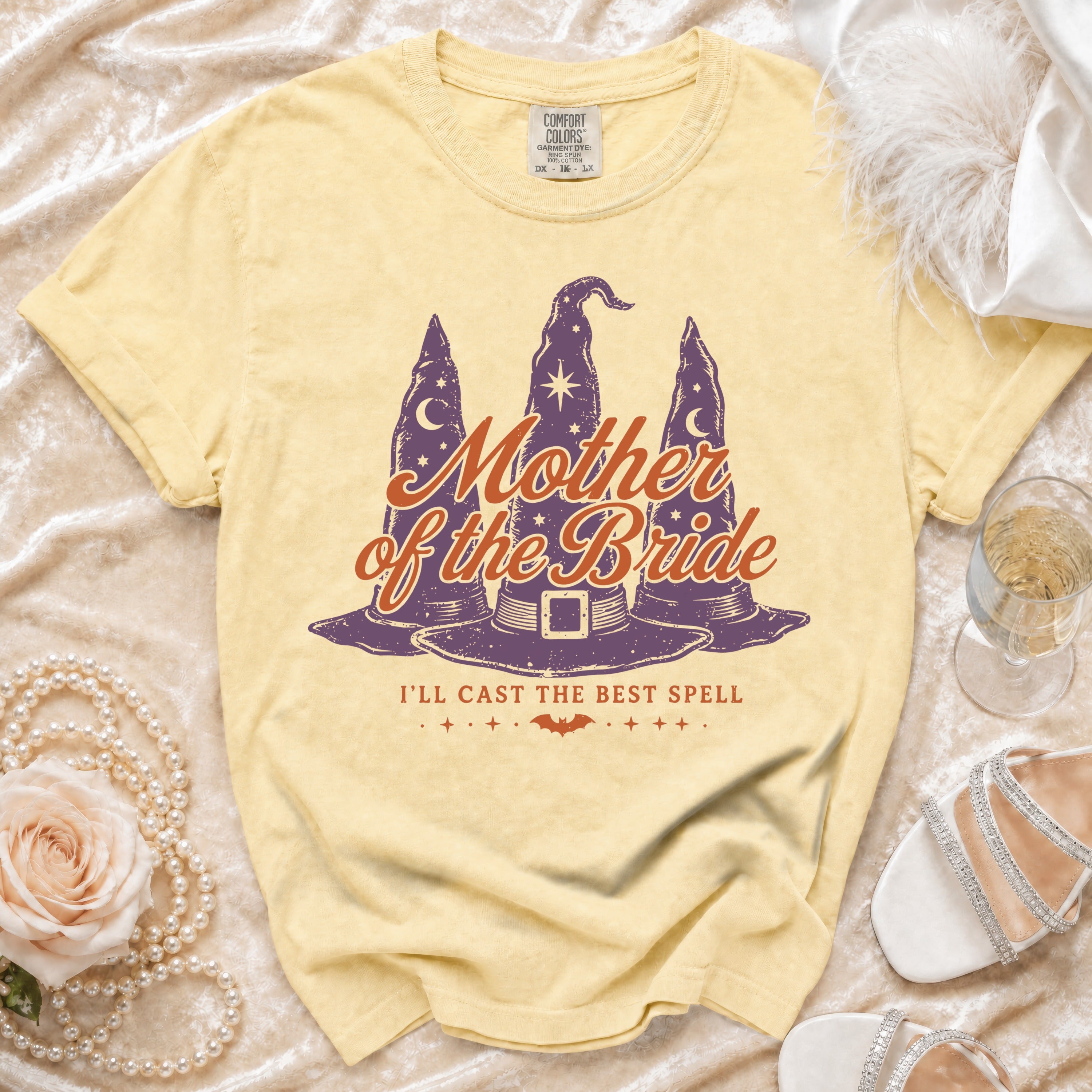 Yellow t-shirt with "Mother of the Bride" and witch hats graphic.