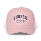 Light pink baseball cap embroidered with dark blue text reading Apres Ski Club.