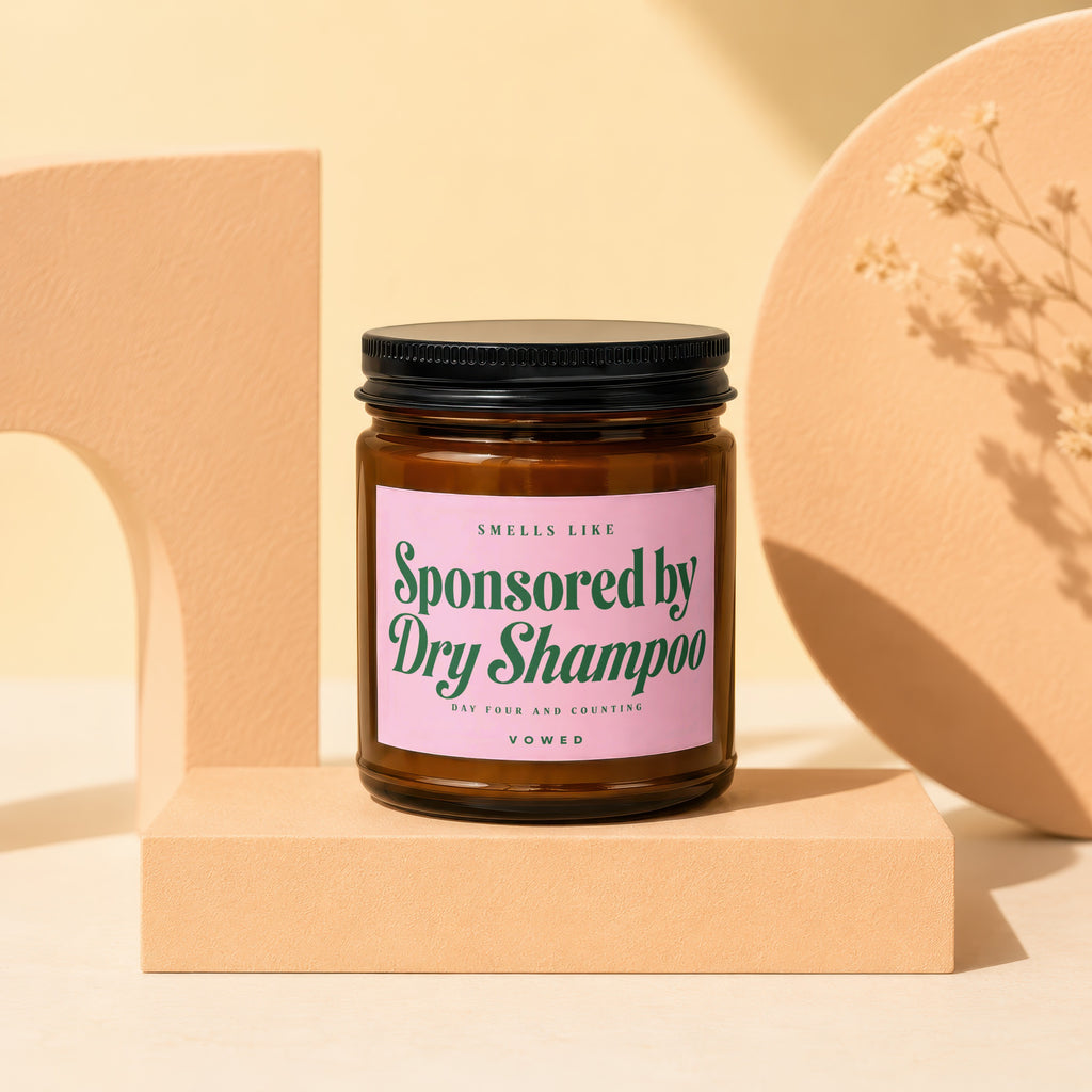 Brown glass jar with pink label that reads "Smells Like Sponsored by Dry Shampoo, Day Four and Counting, VOWED".