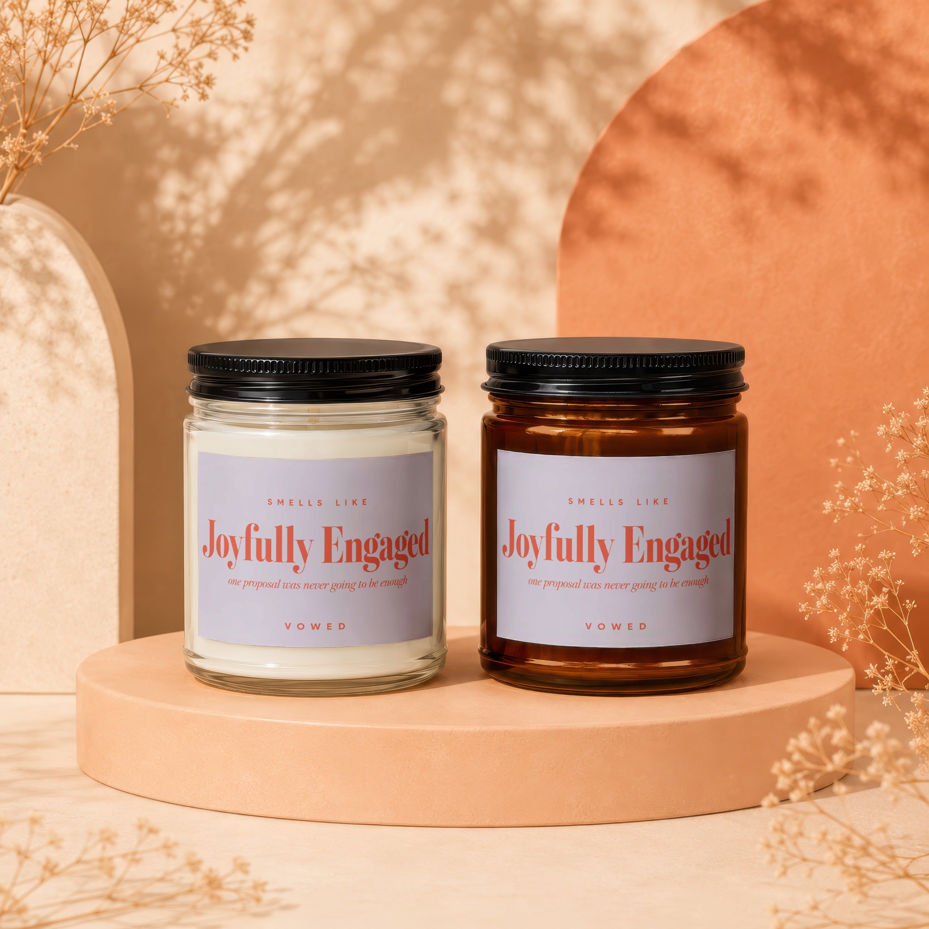 Two candles with "Joyfully Engaged" labels and floral accents.