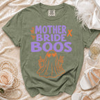 Green t-shirt with "the mother bride boos" text and orange ghost graphic.
