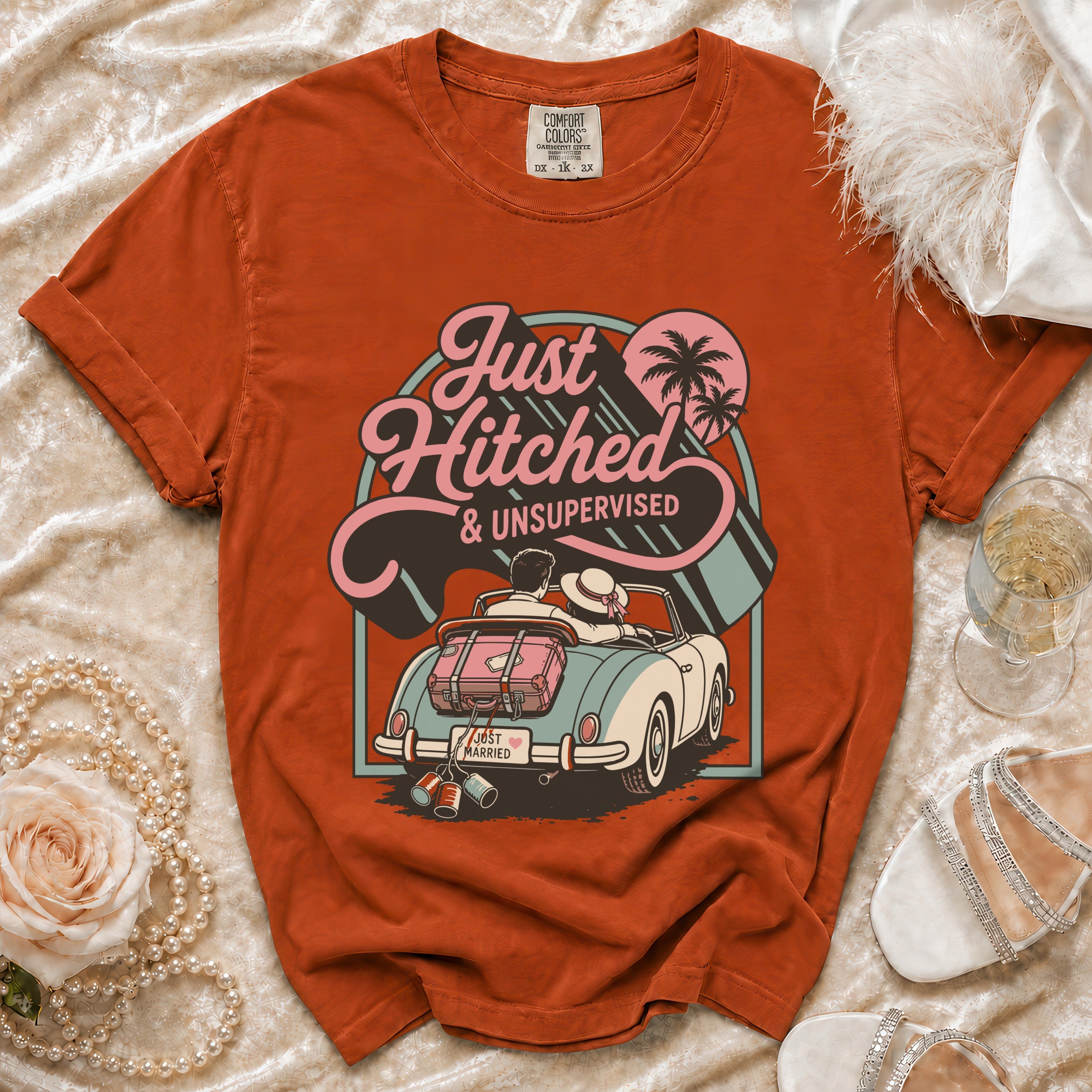T-shirt with "Just Hitched & Unsupervised" text and illustration of a couple in a car.
