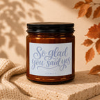 Amber glass candle with "So glad you said yes" text, VOWED.