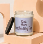 Glass candle with black lid, label reads "One More Last Wedding Favor Vowed".