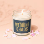 Jar candle with "WARNING: WEDDING CHAOS PROCEED WITH CHAMPAGNE." text, lit wick.
