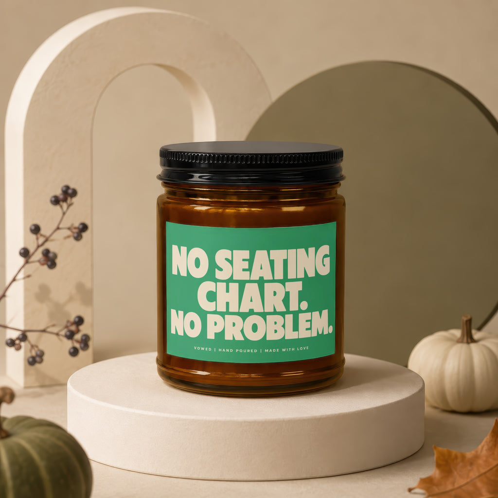 Amber jar candle with a green label reading "NO SEATING CHART. NO PROBLEM."