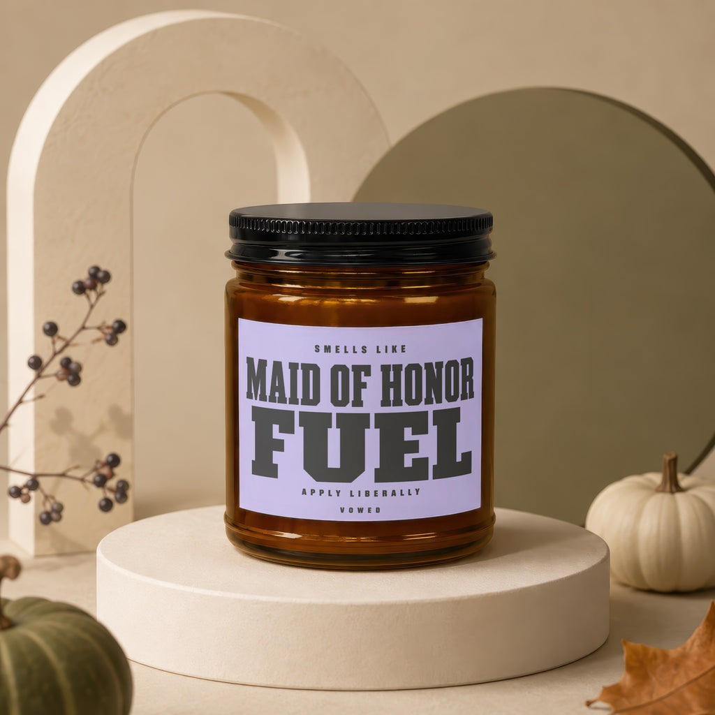 Candle labeled "Maid of Honor Fuel Apply Liberally Vowed" on display pedestal.
