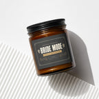 Amber jar candle with "Bride Mode Fully Activated" label and decorative elements.